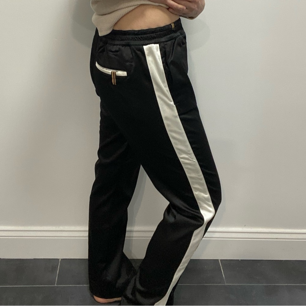 Black satiny track pant with white strip